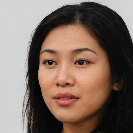 Joyful asian young-adult female with long  black hair and brown eyes