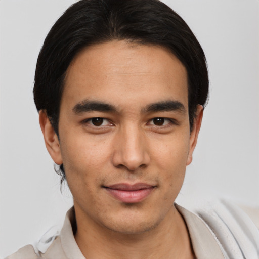 Joyful white young-adult male with short  black hair and brown eyes
