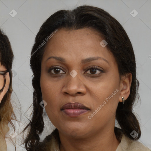 Joyful black adult female with medium  brown hair and brown eyes