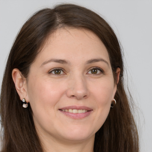 Joyful white young-adult female with long  brown hair and grey eyes