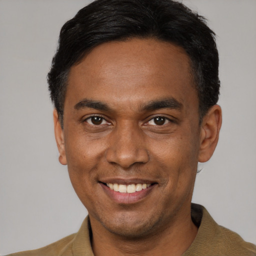 Joyful latino young-adult male with short  black hair and brown eyes