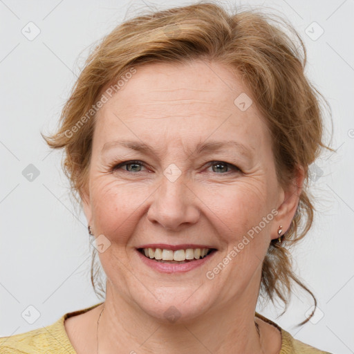 Joyful white adult female with medium  brown hair and blue eyes