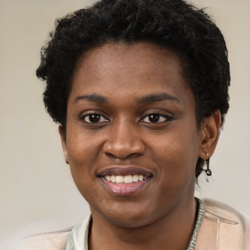 Joyful black young-adult female with short  black hair and brown eyes