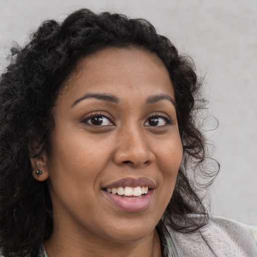 Joyful latino young-adult female with long  brown hair and brown eyes