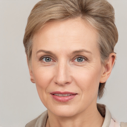 Joyful white adult female with short  brown hair and grey eyes