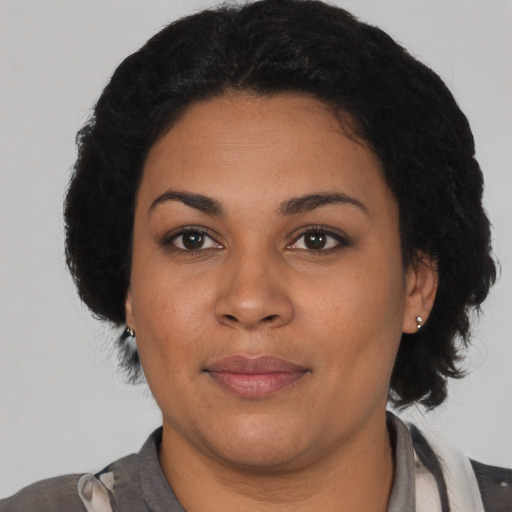 Joyful latino young-adult female with medium  black hair and brown eyes