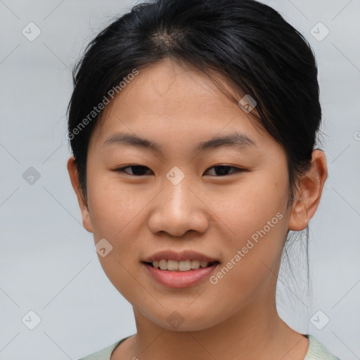 Joyful asian young-adult female with medium  brown hair and brown eyes