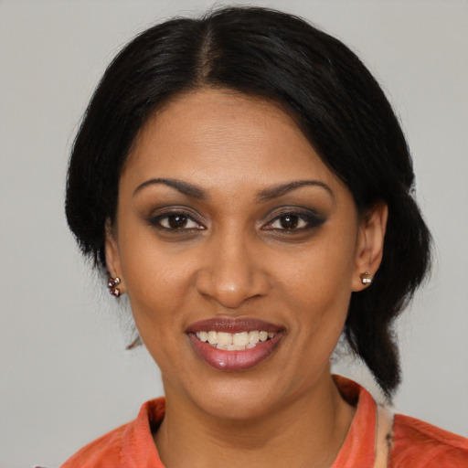 Joyful black young-adult female with medium  black hair and brown eyes