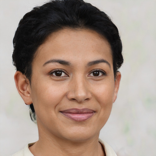 Joyful latino young-adult female with short  brown hair and brown eyes