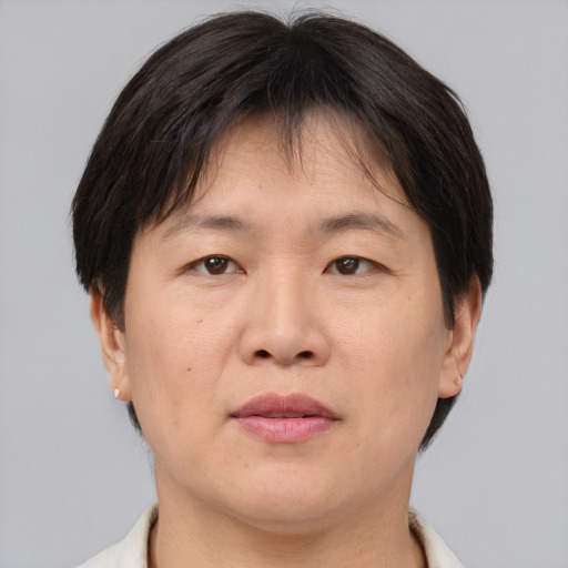 Joyful asian adult female with short  brown hair and brown eyes