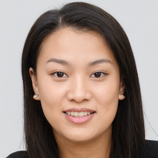Joyful asian young-adult female with long  brown hair and brown eyes