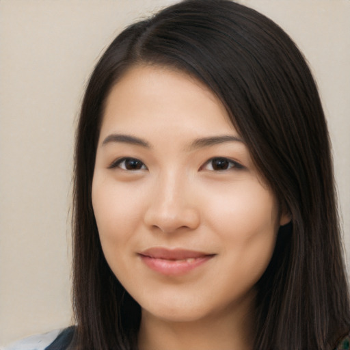 Joyful asian young-adult female with long  brown hair and brown eyes