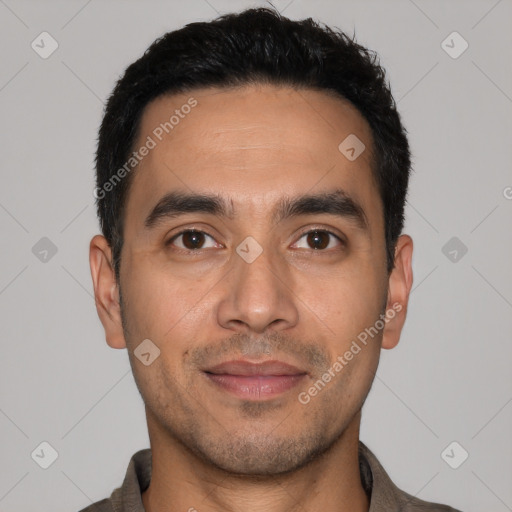 Joyful latino young-adult male with short  black hair and brown eyes