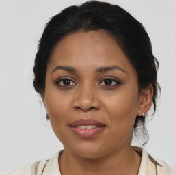 Joyful latino young-adult female with medium  brown hair and brown eyes