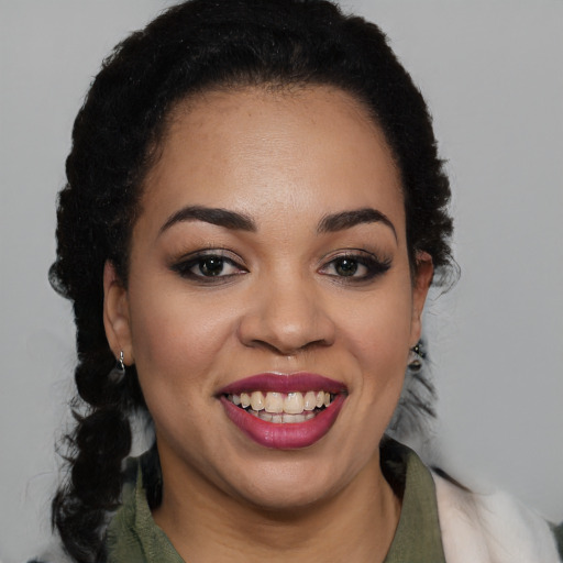 Joyful black young-adult female with short  black hair and brown eyes