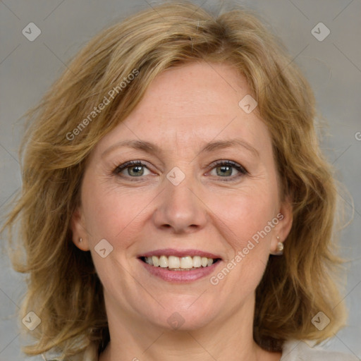 Joyful white adult female with medium  brown hair and blue eyes