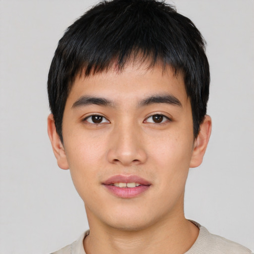 Joyful asian young-adult male with short  black hair and brown eyes