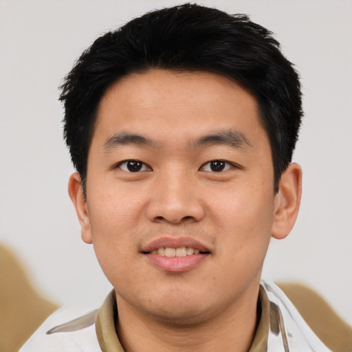 Joyful asian young-adult male with short  black hair and brown eyes