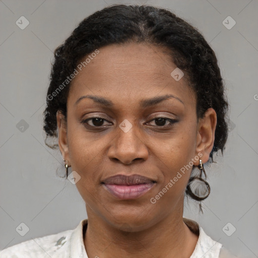 Joyful black adult female with short  brown hair and brown eyes