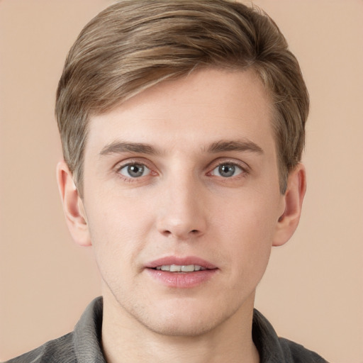 Joyful white young-adult male with short  brown hair and grey eyes