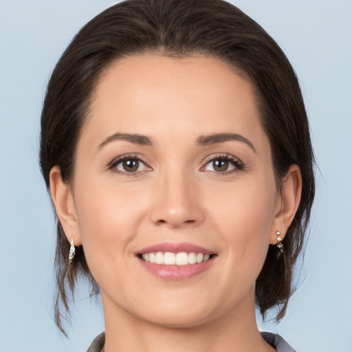 Joyful white young-adult female with medium  brown hair and brown eyes