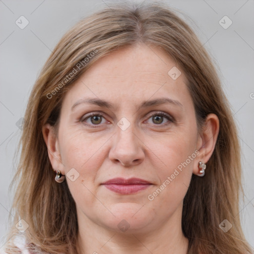 Joyful white adult female with long  brown hair and grey eyes