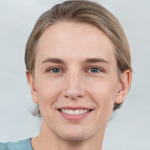 Joyful white young-adult female with short  brown hair and grey eyes