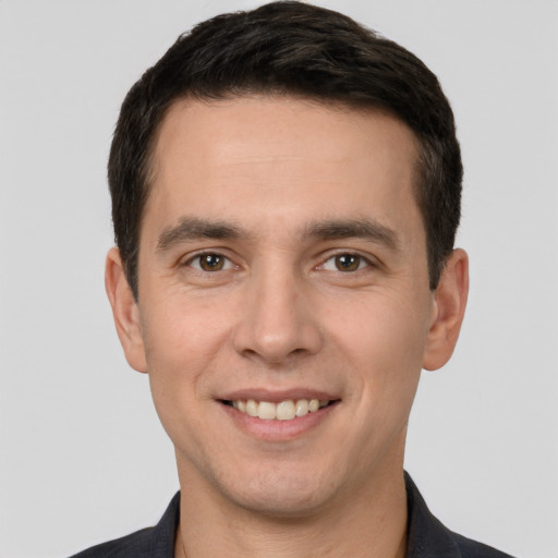 Joyful white young-adult male with short  brown hair and brown eyes