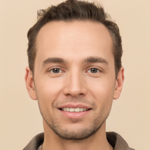 Joyful white young-adult male with short  brown hair and brown eyes