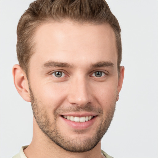 Joyful white young-adult male with short  brown hair and grey eyes