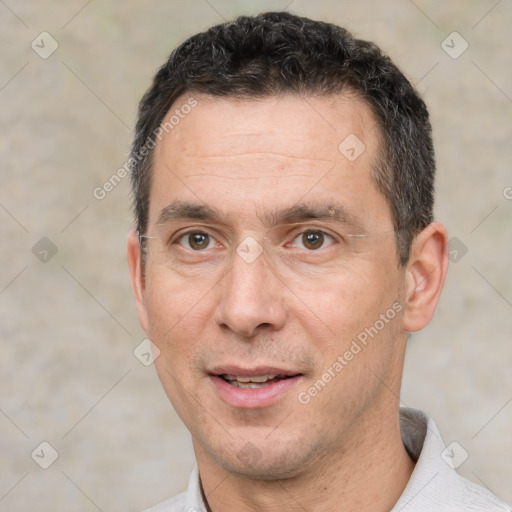 Joyful white adult male with short  black hair and brown eyes