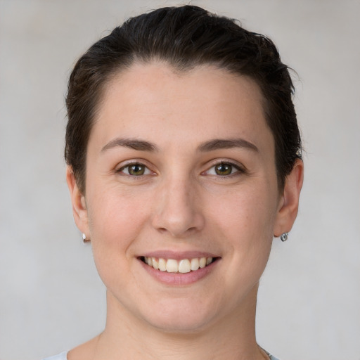 Joyful white young-adult female with short  brown hair and brown eyes