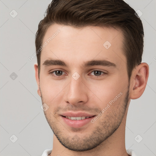 Joyful white young-adult male with short  brown hair and brown eyes