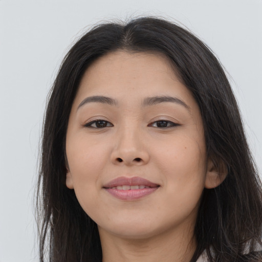 Joyful asian young-adult female with long  brown hair and brown eyes