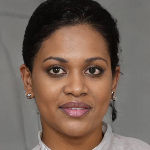 Joyful black young-adult female with short  brown hair and brown eyes