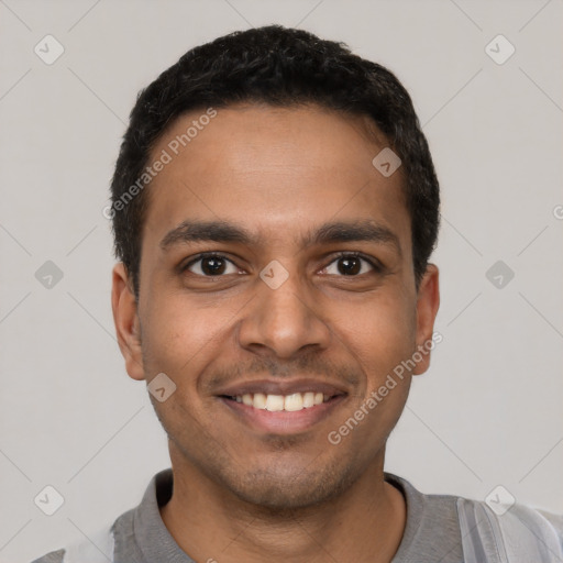 Joyful latino young-adult male with short  black hair and brown eyes