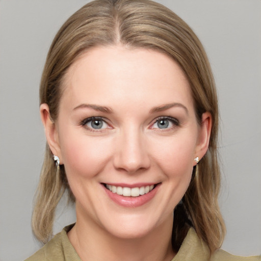 Joyful white young-adult female with medium  brown hair and blue eyes