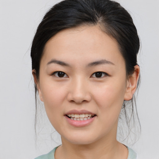 Joyful asian young-adult female with medium  brown hair and brown eyes