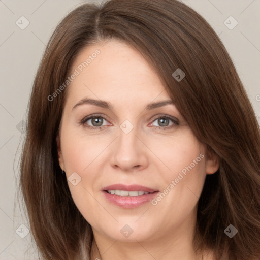 Joyful white adult female with long  brown hair and brown eyes