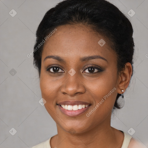 Joyful black young-adult female with short  black hair and brown eyes