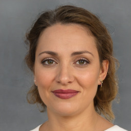 Joyful white adult female with medium  brown hair and brown eyes