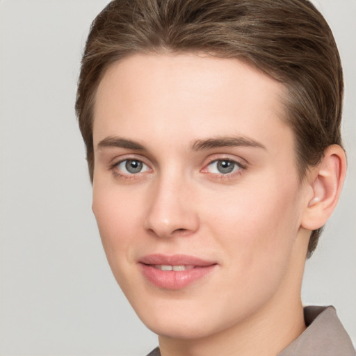 Joyful white young-adult female with short  brown hair and grey eyes