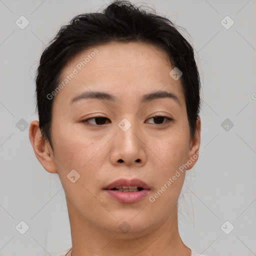 Joyful asian young-adult female with short  brown hair and brown eyes