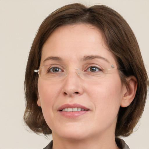 Joyful white adult female with medium  brown hair and grey eyes