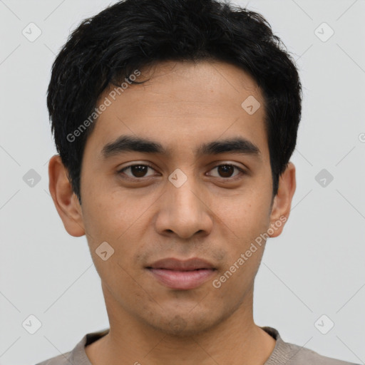 Joyful latino young-adult male with short  black hair and brown eyes