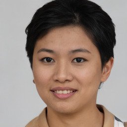 Joyful asian young-adult female with short  brown hair and brown eyes