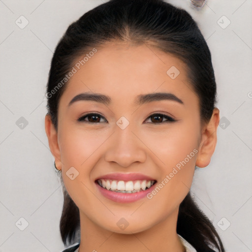 Joyful latino young-adult female with long  brown hair and brown eyes