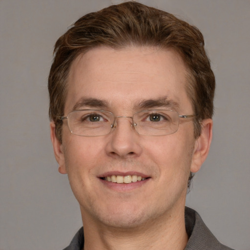 Joyful white adult male with short  brown hair and grey eyes