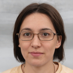 Joyful white adult female with medium  brown hair and brown eyes