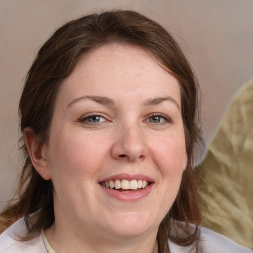 Joyful white adult female with medium  brown hair and grey eyes